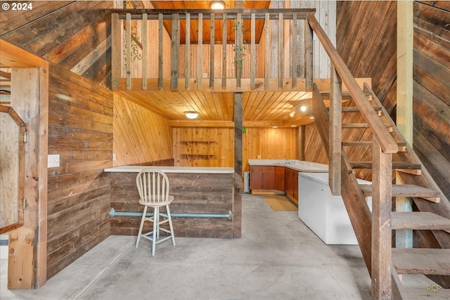 interior space featuring wooden walls and vaulted ceiling