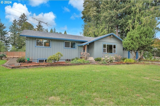 ranch-style home with a front lawn