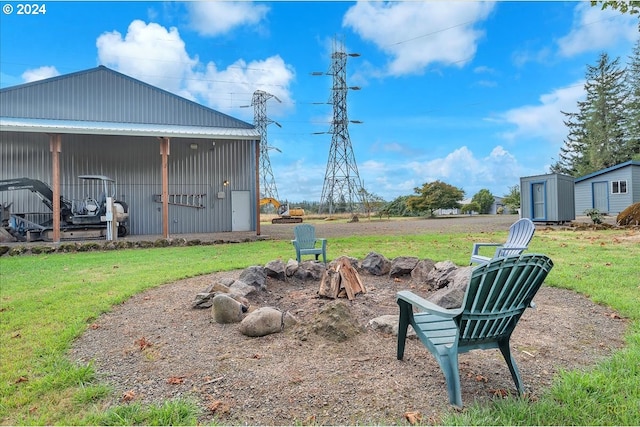 view of yard featuring a shed and a fire pit