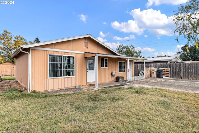 back of property featuring a lawn