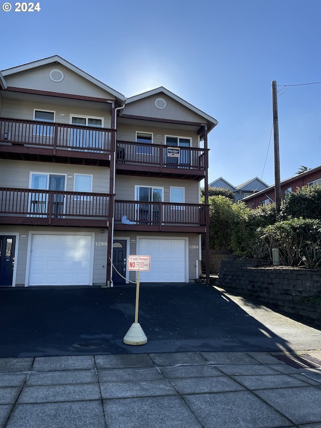 view of front of house with a garage and a balcony