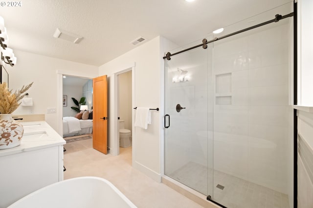 full bathroom with toilet, a textured ceiling, separate shower and tub, and vanity