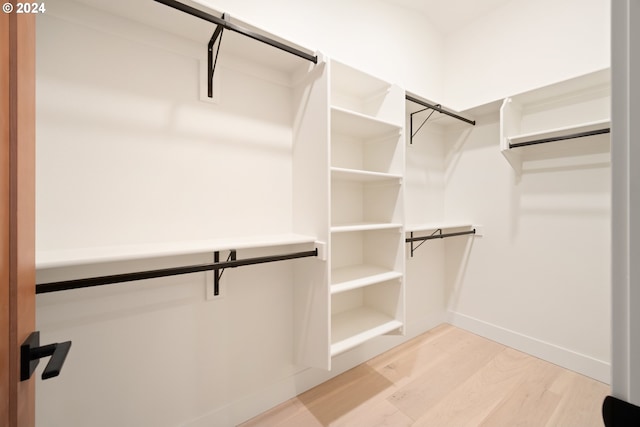 walk in closet with hardwood / wood-style flooring