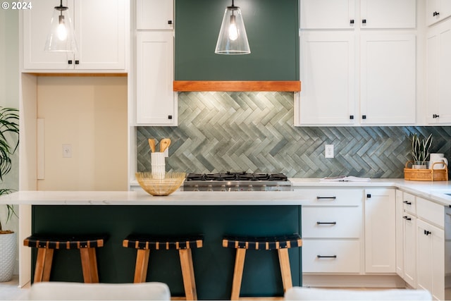 kitchen featuring white cabinets, hanging light fixtures, ventilation hood, and decorative backsplash