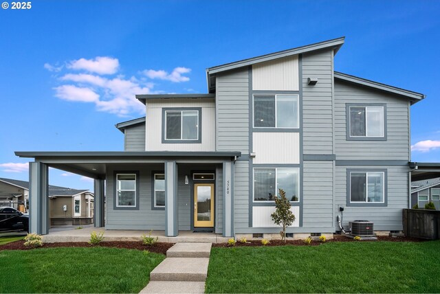 view of front of house featuring a porch, central AC, and a front lawn