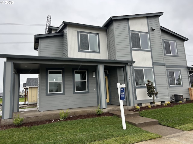 view of front of home with a porch, central AC, and a front yard