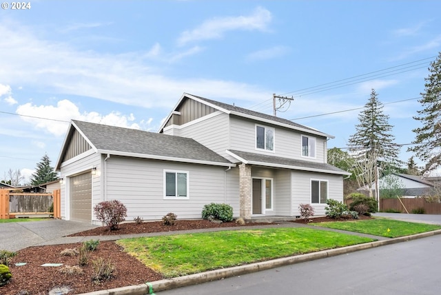 front facade featuring a front yard and a garage