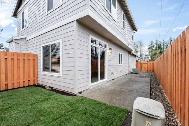 view of home's exterior with central air condition unit, a patio area, and a yard