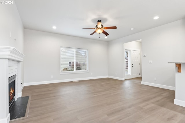 unfurnished living room featuring ceiling fan and light hardwood / wood-style flooring