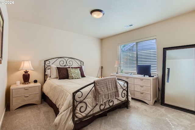 bedroom featuring light colored carpet