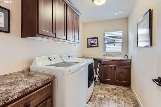 laundry room with separate washer and dryer, sink, and cabinets