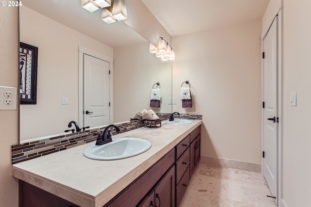 bathroom featuring vanity and tasteful backsplash