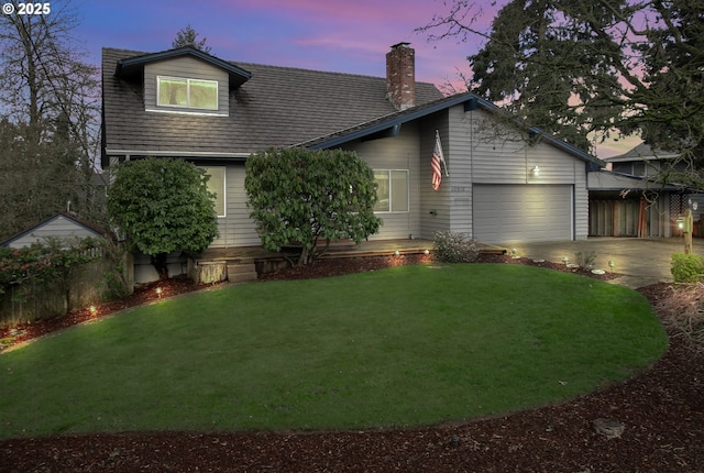 view of front of home featuring a lawn, a garage, driveway, and a chimney