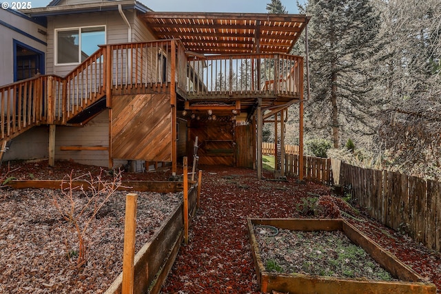 exterior space featuring stairs, a vegetable garden, and fence