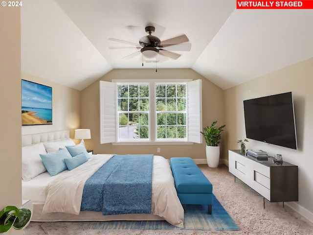 bedroom with ceiling fan, light colored carpet, and lofted ceiling