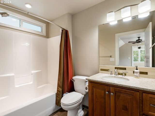 full bathroom with ceiling fan, toilet, shower / bath combo with shower curtain, and vanity