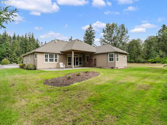 back of house with a lawn and a patio area