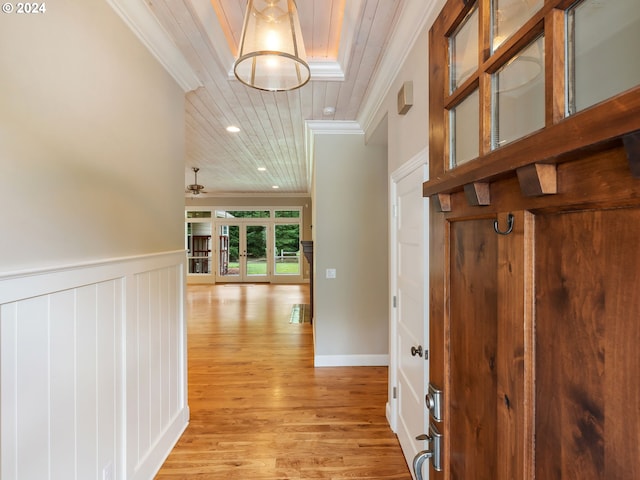 hallway featuring ornamental molding and light wood-type flooring