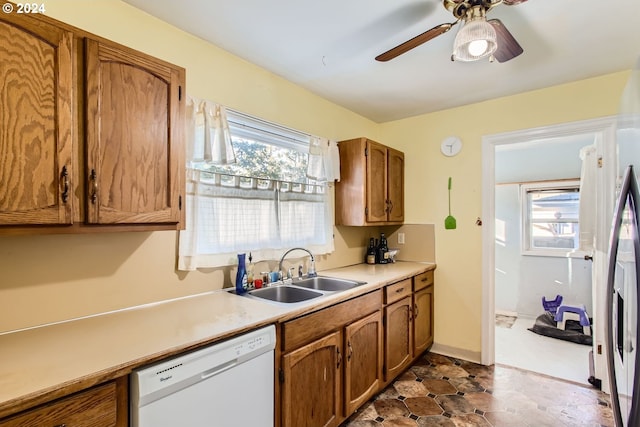 kitchen featuring white dishwasher, sink, and ceiling fan