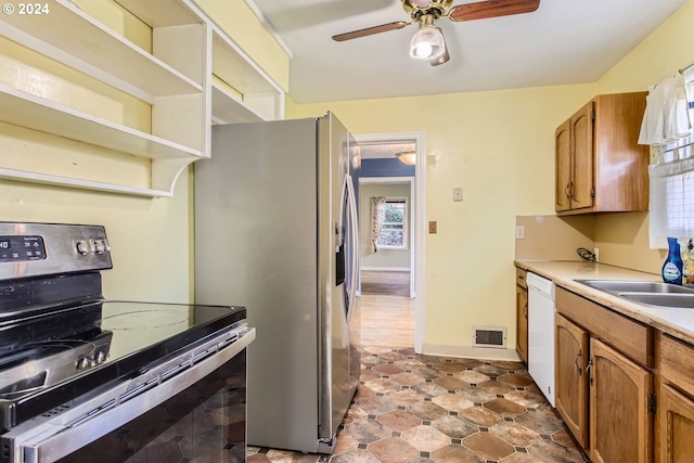 kitchen featuring dishwasher, sink, stainless steel fridge with ice dispenser, black range with electric stovetop, and ceiling fan