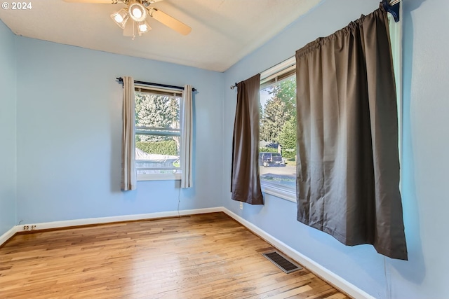 unfurnished room featuring ceiling fan, plenty of natural light, and light wood-type flooring