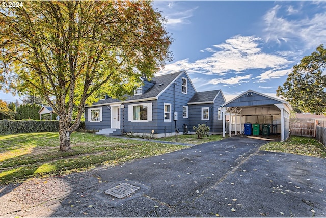 view of front of home with a front lawn and a carport