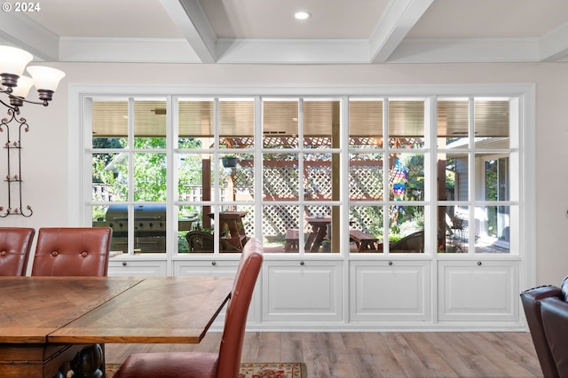 dining area featuring beamed ceiling, crown molding, and light wood-type flooring