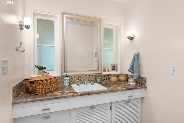 bathroom with vanity and decorative backsplash