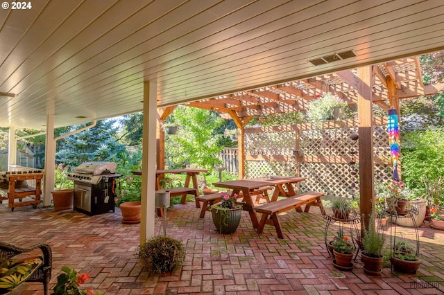 view of patio with a grill and a pergola