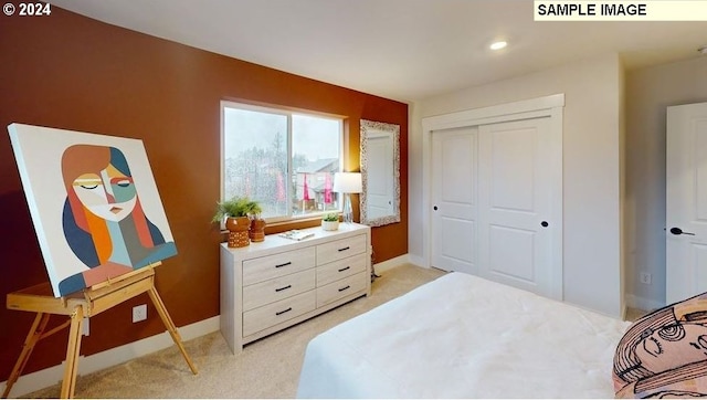 bedroom featuring light carpet and a closet