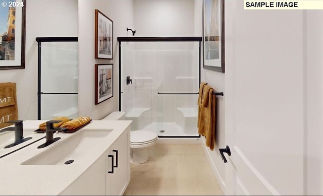 bathroom with an enclosed shower, vanity, and toilet