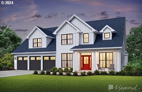 view of front of house featuring a garage and a yard