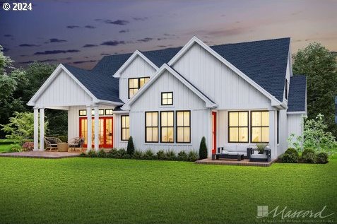 back house at dusk with a patio, an outdoor hangout area, and a yard