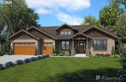 view of front of property featuring a garage and a front yard