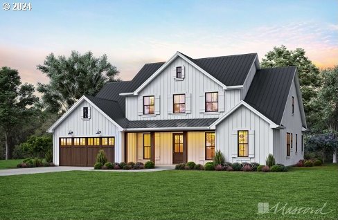 modern farmhouse featuring a garage, a lawn, and covered porch