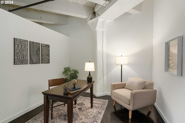 home office featuring beam ceiling and dark wood-type flooring