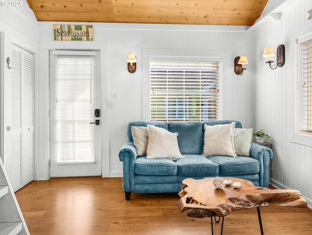 living room with wood ceiling, a wealth of natural light, and hardwood / wood-style floors