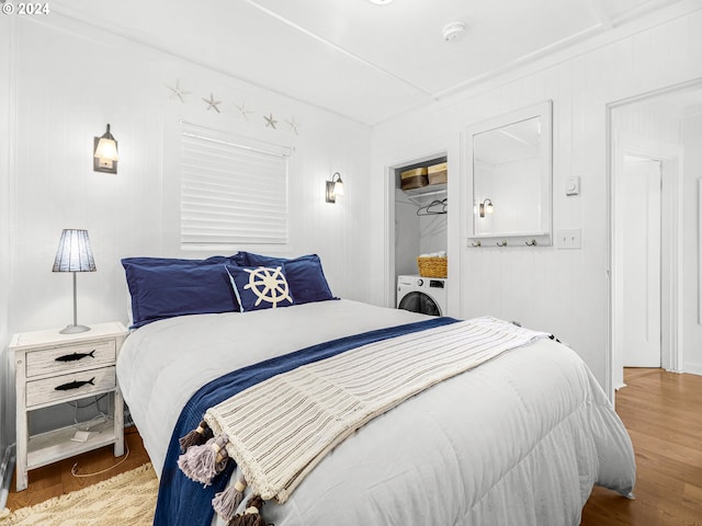 bedroom with washer / clothes dryer and hardwood / wood-style floors