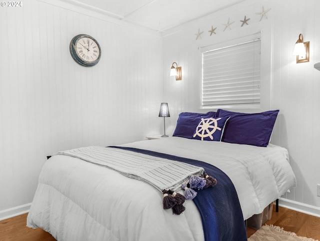 bedroom with crown molding and hardwood / wood-style floors