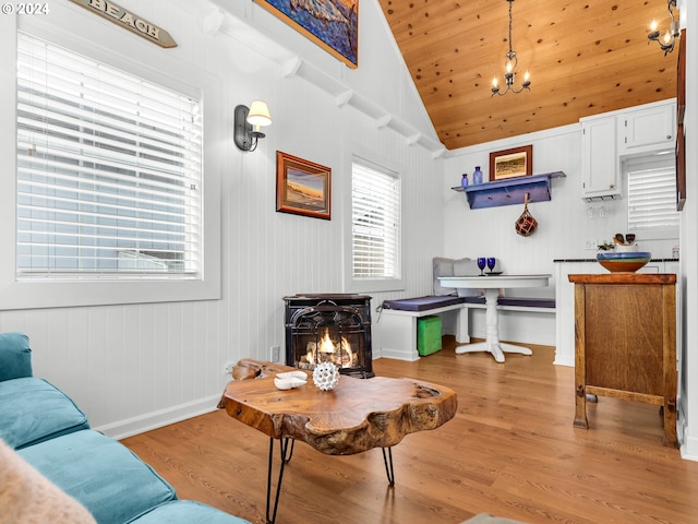 living room with light hardwood / wood-style floors, wooden ceiling, vaulted ceiling, and a fireplace