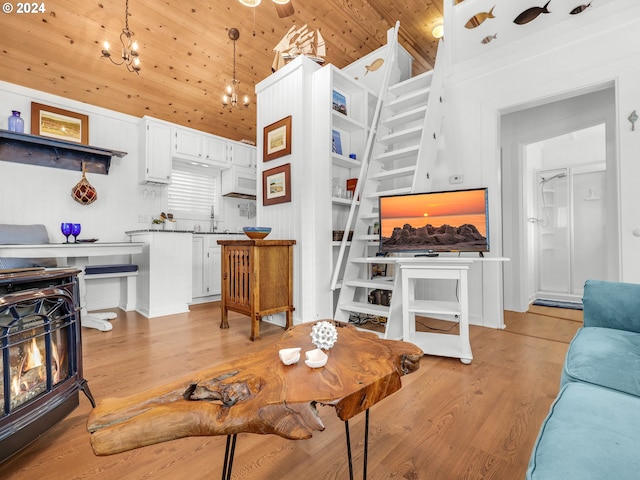 living room with wooden ceiling, sink, a notable chandelier, high vaulted ceiling, and light hardwood / wood-style floors