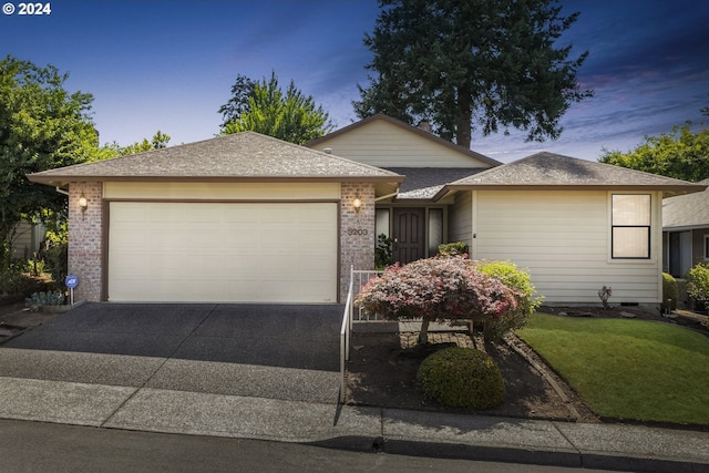 view of front of property featuring a yard and a garage