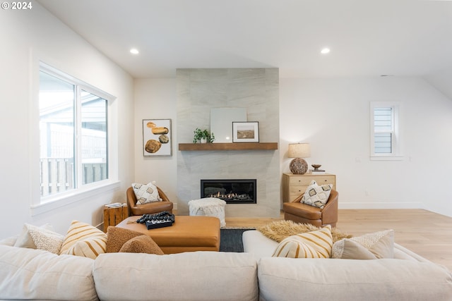 kitchen with a large fireplace, extractor fan, appliances with stainless steel finishes, pendant lighting, and sink