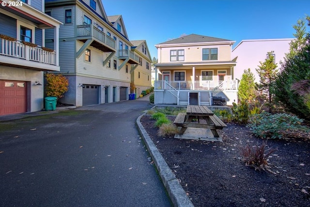 exterior space featuring covered porch and an attached garage