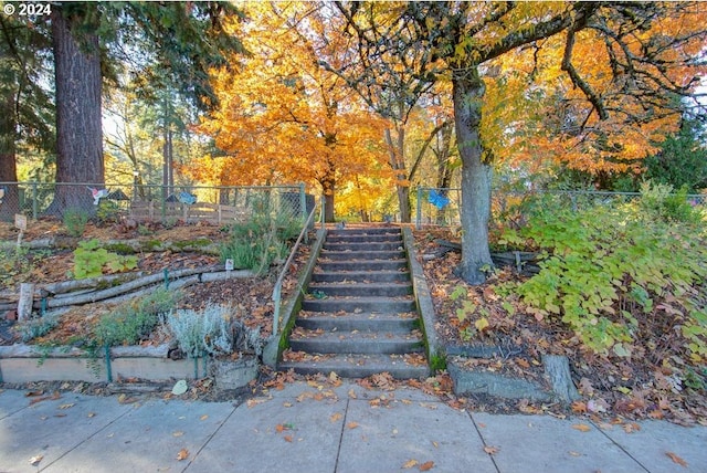 surrounding community featuring stairs and fence