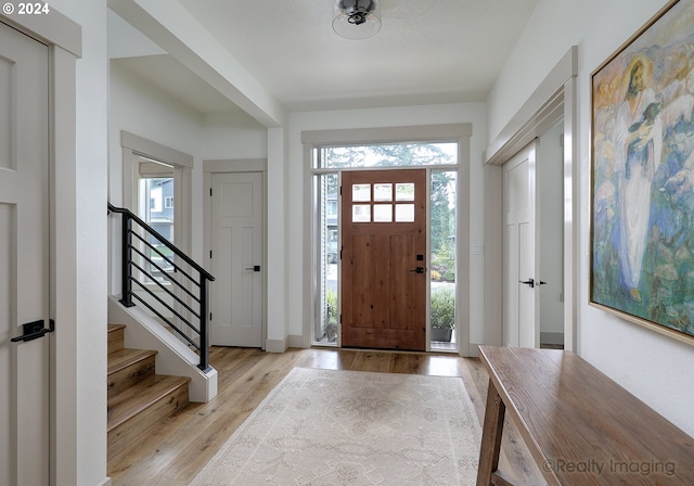 foyer entrance featuring light wood-type flooring and plenty of natural light