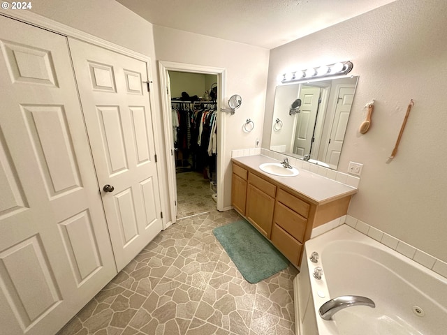 146 28th St, Long Beach, WA 98631 - bathroom with vanity, a whirlpool tub, and a spacious closet