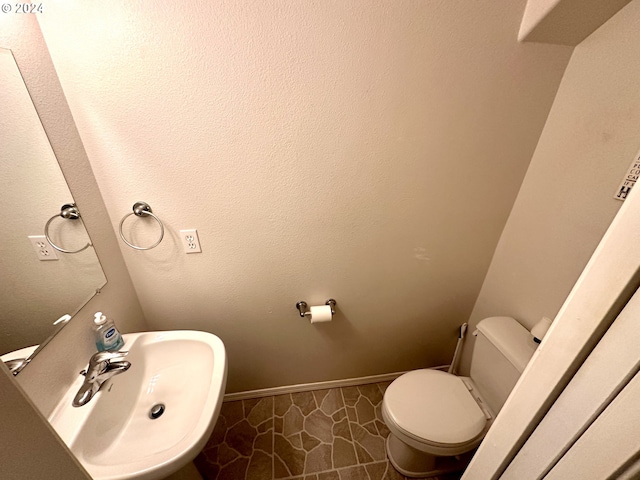 146 28th St, Long Beach, WA 98631 - bathroom featuring a sink, toilet, and baseboards
