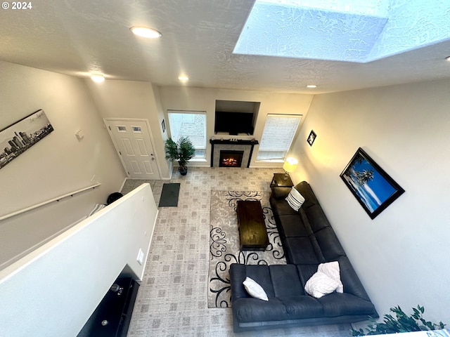 146 28th St, Long Beach, WA 98631 - living room featuring a lit fireplace, a textured ceiling, tile patterned floors, and recessed lighting