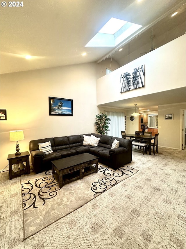 living room with a skylight, carpet floors, and high vaulted ceiling